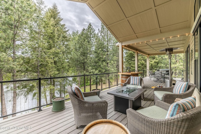 396 Hanaford Rd, Blanchard, ID 83804 - wooden deck with an outdoor living space with a fire pit and a ceiling fan