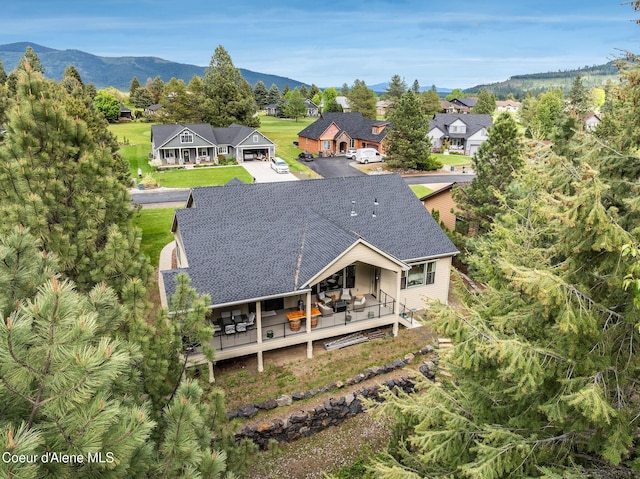 396 Hanaford Rd, Blanchard, ID 83804 - back of property with roof with shingles, asphalt driveway, a mountain view, a residential view, and a garage