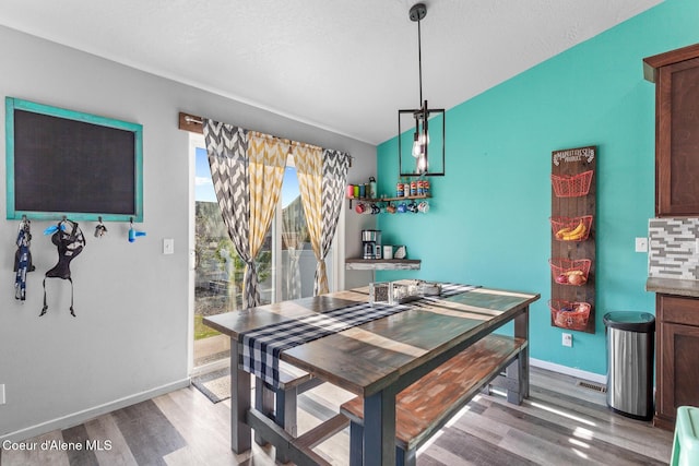 3283 N Knob Creek Ct, Post Falls, ID 83854 - dining area with light wood-type flooring, baseboards, and lofted ceiling