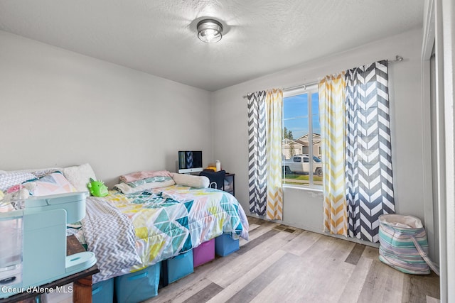3283 N Knob Creek Ct, Post Falls, ID 83854 - bedroom with wood finished floors and a textured ceiling