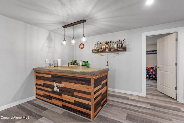 3283 N Knob Creek Ct, Post Falls, ID 83854 - indoor dry bar featuring baseboards, wood finished floors, and decorative light fixtures