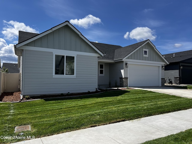 3387 N Cyprus Fox Loop, Post Falls, ID 83854 - view of front of home with board and batten siding, concrete driveway, a garage, and a shingled roof