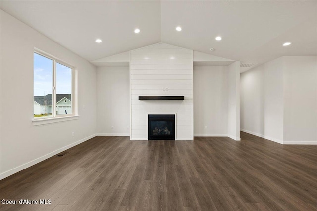 3387 N Cyprus Fox Loop, Post Falls, ID 83854 - unfurnished living room featuring dark wood-type flooring, a fireplace, baseboards, recessed lighting, and vaulted ceiling