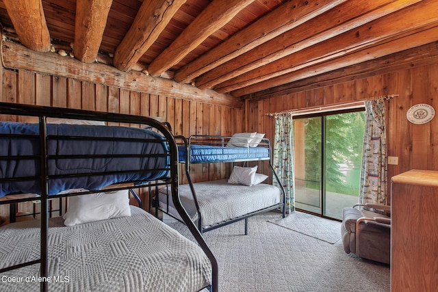 8457 N Powell Way, Hayden, ID 83835 - carpeted bedroom with access to exterior, wooden walls, and wood ceiling with exposed beams