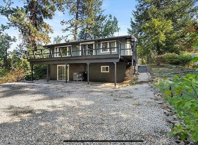 31961 N 3rd Ave, Spirit Lake, ID 83869 - view of front facade with a wooden deck and a patio area