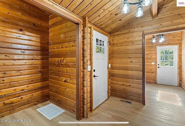 31961 N 3rd Ave, Spirit Lake, ID 83869 - entryway with light wood-style flooring, lofted ceiling, wood ceiling, and wood walls