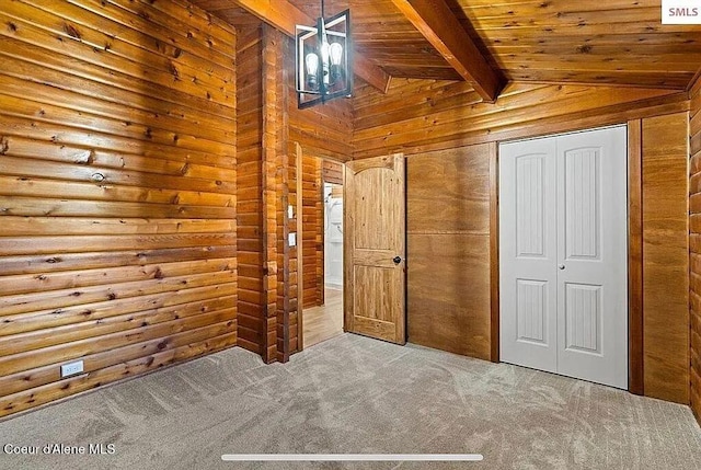 31961 N 3rd Ave, Spirit Lake, ID 83869 - unfurnished bedroom featuring wood walls, carpet, wood ceiling, and a closet