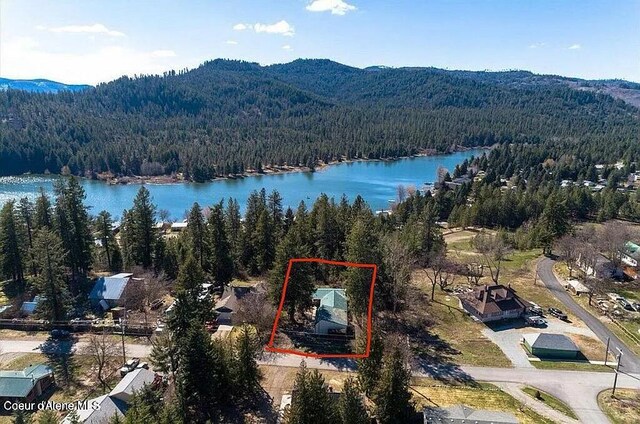 31961 N 3rd Ave, Spirit Lake, ID 83869 - aerial view of property's location featuring a forest, a water and mountain view, and property parcel outlined