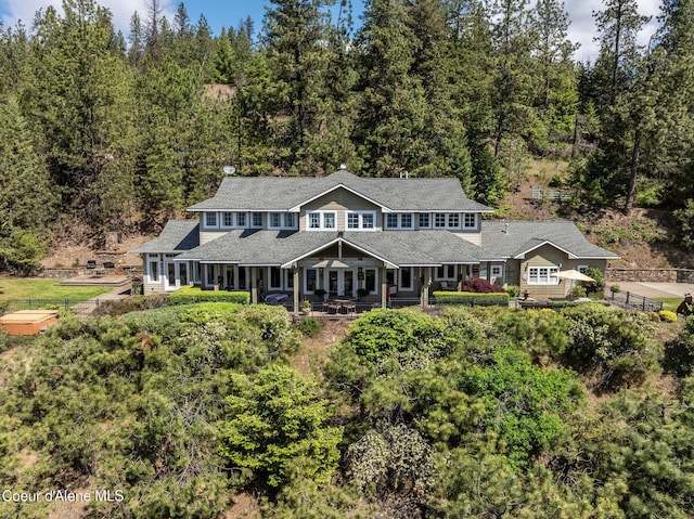 4878 E Annapolis Ct, Coeur Dalene, ID 83814 - back of house featuring a porch and a forest view