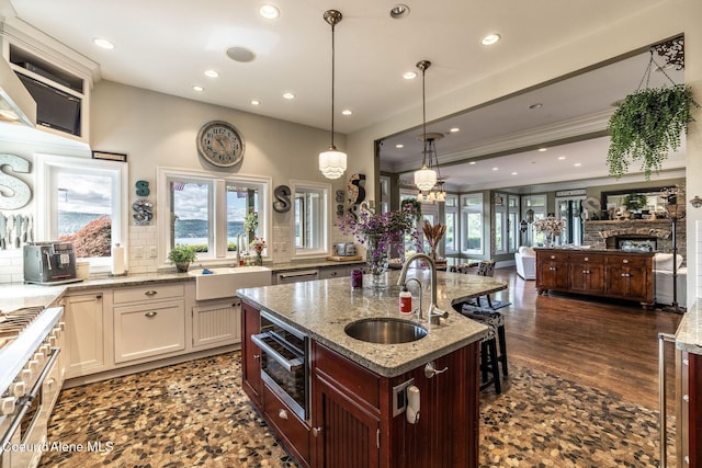 4878 E Annapolis Ct, Coeur Dalene, ID 83814 - kitchen with a sink, light stone countertops, open floor plan, recessed lighting, and tasteful backsplash