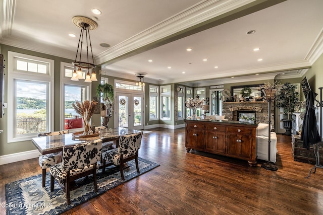 4878 E Annapolis Ct, Coeur Dalene, ID 83814 - dining space featuring plenty of natural light, ornamental molding, dark wood finished floors, baseboards, and a fireplace