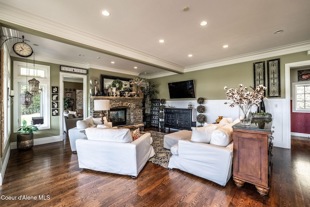 4878 E Annapolis Ct, Coeur Dalene, ID 83814 - living area with a fireplace, dark wood-style flooring, crown molding, recessed lighting, and wainscoting