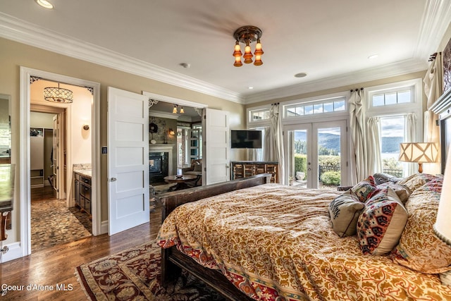 4878 E Annapolis Ct, Coeur Dalene, ID 83814 - bedroom featuring access to outside, a glass covered fireplace, french doors, ornamental molding, and dark wood-style floors