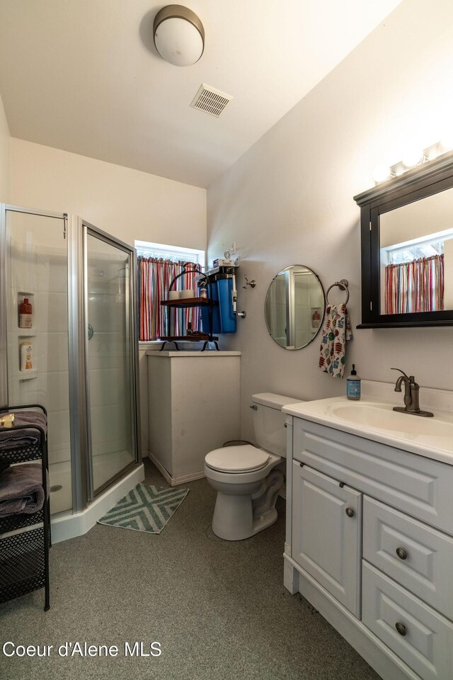 4878 E Annapolis Ct, Coeur Dalene, ID 83814 - bathroom featuring a shower stall, vanity, toilet, and carpet flooring
