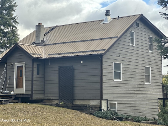 366 Yukon Rd, Bonners Ferry, ID 83805 - back of house with a chimney, metal roof, and entry steps