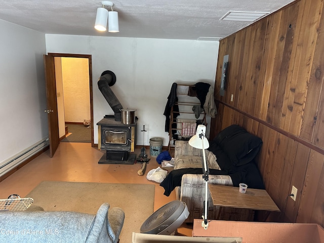 366 Yukon Rd, Bonners Ferry, ID 83805 - living room with a wood stove and a baseboard radiator