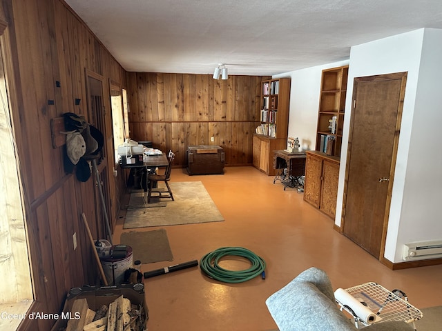 366 Yukon Rd, Bonners Ferry, ID 83805 - dining area with wood walls, concrete flooring, and baseboard heating