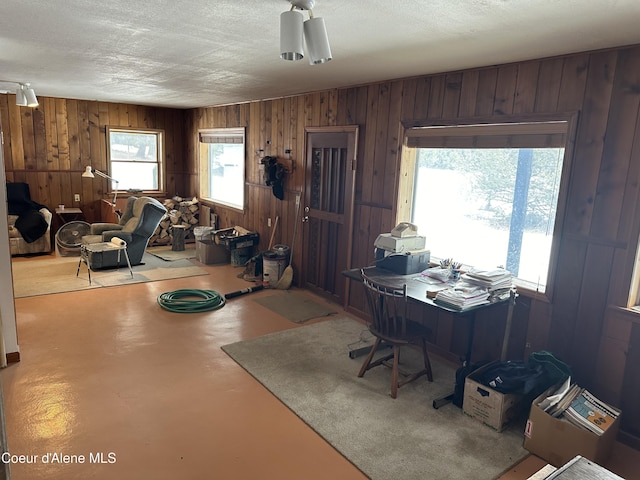 366 Yukon Rd, Bonners Ferry, ID 83805 - office with wooden walls, finished concrete flooring, and a textured ceiling