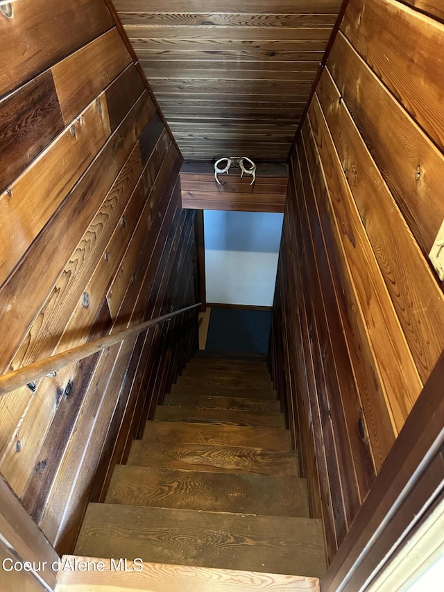 366 Yukon Rd, Bonners Ferry, ID 83805 - stairs with wood walls, wood ceiling, hardwood / wood-style floors, and vaulted ceiling