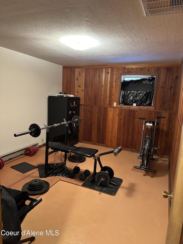 366 Yukon Rd, Bonners Ferry, ID 83805 - workout room with wood walls and a textured ceiling
