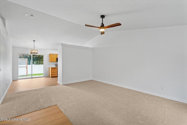 1374 W Timor Ave, Coeur Dalene, ID 83815 - unfurnished room with light colored carpet, ceiling fan, baseboards, and vaulted ceiling
