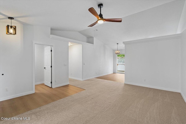1374 W Timor Ave, Coeur Dalene, ID 83815 - spare room with lofted ceiling, ceiling fan, carpet flooring, baseboards, and wood finished floors