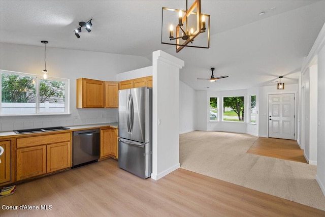 1374 W Timor Ave, Coeur Dalene, ID 83815 - kitchen featuring appliances with stainless steel finishes, lofted ceiling, light wood-style floors, decorative light fixtures, and baseboards