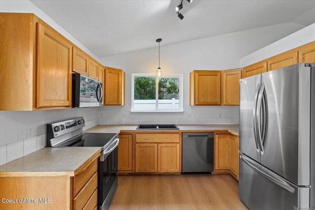 1374 W Timor Ave, Coeur Dalene, ID 83815 - kitchen with stainless steel appliances, lofted ceiling, light wood-style floors, light countertops, and decorative light fixtures