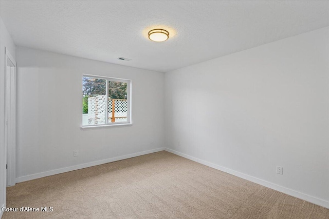 1374 W Timor Ave, Coeur Dalene, ID 83815 - carpeted empty room featuring baseboards and a textured ceiling