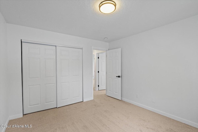 1374 W Timor Ave, Coeur Dalene, ID 83815 - unfurnished bedroom with carpet floors, baseboards, and a closet