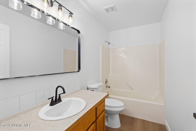 1374 W Timor Ave, Coeur Dalene, ID 83815 - bathroom with toilet, decorative backsplash, vanity, bathtub / shower combination, and wood finished floors