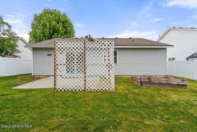1374 W Timor Ave, Coeur Dalene, ID 83815 - rear view of property featuring a vegetable garden