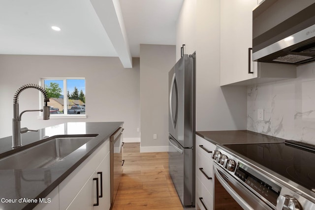 1682 Onyx Ct 1670, 1674 1678, Sandpoint, ID 83864 - kitchen with stainless steel appliances, a sink, backsplash, white cabinetry, and dark countertops