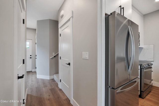 1682 Onyx Ct 1670, 1674 1678, Sandpoint, ID 83864 - kitchen featuring stainless steel appliances, wood finished floors, baseboards, and white cabinetry