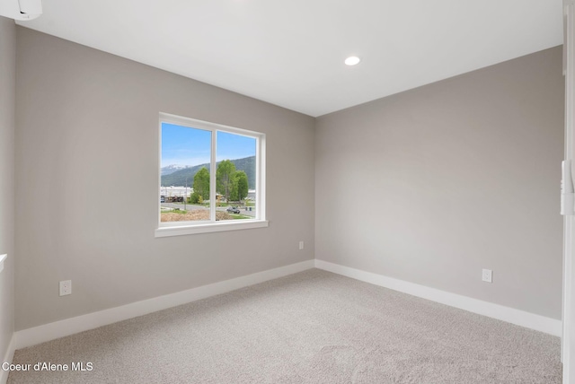 1682 Onyx Ct 1670, 1674 1678, Sandpoint, ID 83864 - spare room with carpet, recessed lighting, a mountain view, baseboards, and a wall mounted AC