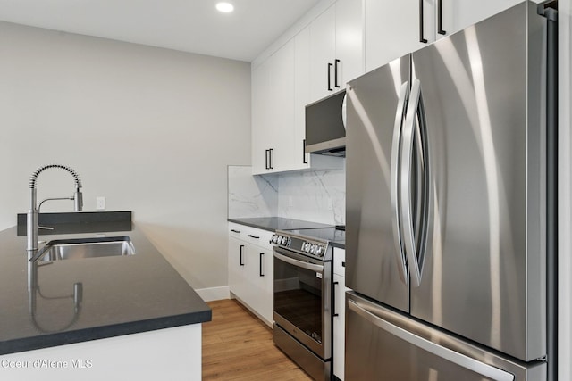 1682 Onyx Ct 1670, 1674 1678, Sandpoint, ID 83864 - kitchen featuring stainless steel appliances, a sink, dark countertops, decorative backsplash, and recessed lighting