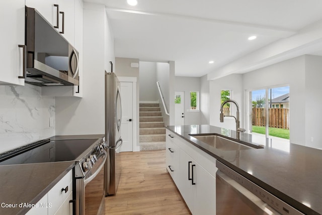 1682 Onyx Ct 1670, 1674 1678, Sandpoint, ID 83864 - kitchen featuring appliances with stainless steel finishes, a sink, light wood finished floors, plenty of natural light, and recessed lighting