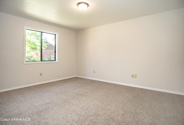 1130 E Timber Ln # 7, Coeur Dalene, ID 83815 - spare room featuring carpet floors and baseboards