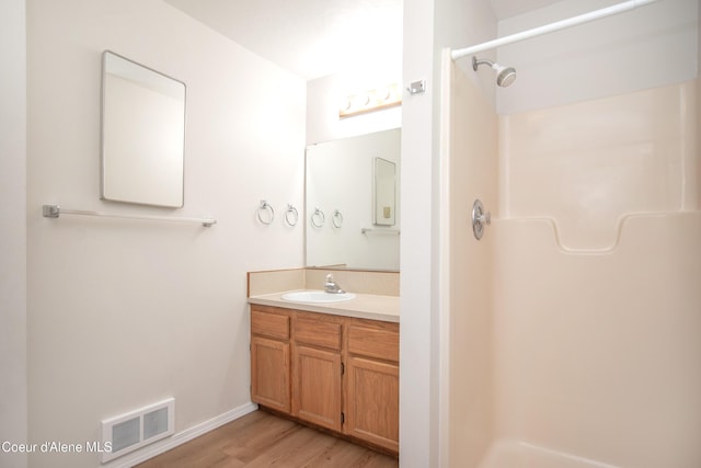 1130 E Timber Ln # 7, Coeur Dalene, ID 83815 - bathroom with a shower, vanity, wood finished floors, and baseboards