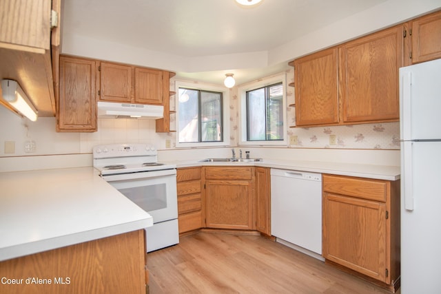 1130 E Timber Ln # 7, Coeur Dalene, ID 83815 - kitchen featuring white appliances, under cabinet range hood, a sink, light wood-style floors, and light countertops