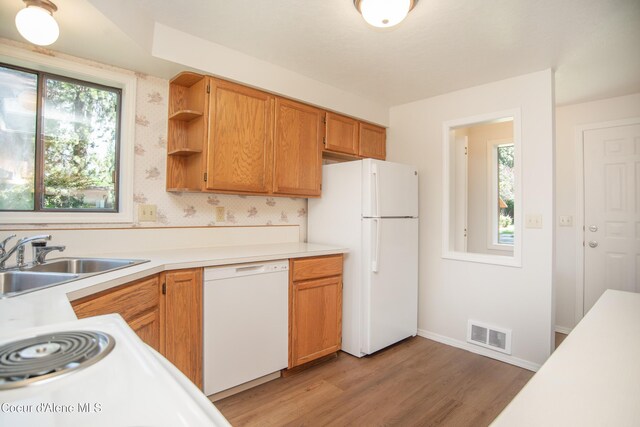 1130 E Timber Ln # 7, Coeur Dalene, ID 83815 - kitchen with white appliances, a sink, healthy amount of natural light, and light countertops
