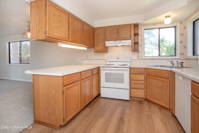 1130 E Timber Ln # 7, Coeur Dalene, ID 83815 - kitchen featuring white appliances, under cabinet range hood, a sink, light countertops, and a peninsula