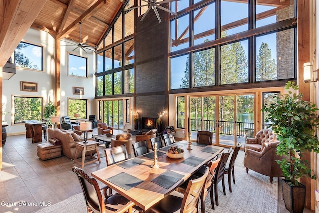 14318 N Waters Edge Ct, Hayden, ID 83835 - dining space with high vaulted ceiling, a ceiling fan, wooden ceiling with exposed beams, healthy amount of natural light, and baseboards