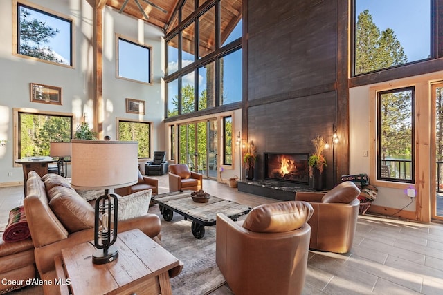 14318 N Waters Edge Ct, Hayden, ID 83835 - living area featuring high vaulted ceiling, a fireplace, baseboards, and wood ceiling