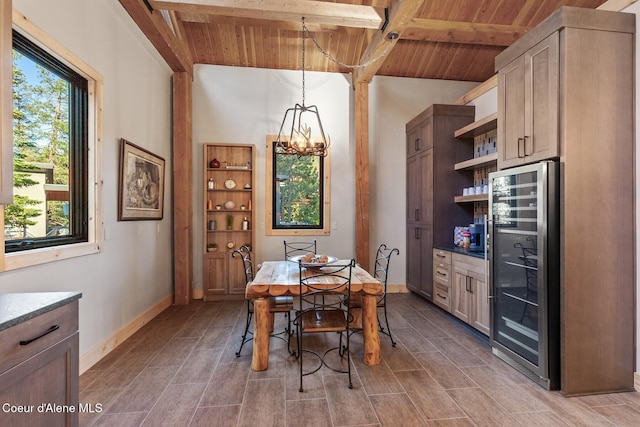 14318 N Waters Edge Ct, Hayden, ID 83835 - dining room with beverage cooler, wood ceiling with exposed beams, baseboards, a chandelier, and a bar