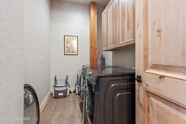 14318 N Waters Edge Ct, Hayden, ID 83835 - laundry area featuring washing machine and clothes dryer, cabinet space, baseboards, and light tile patterned floors