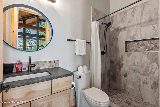 14318 N Waters Edge Ct, Hayden, ID 83835 - bathroom featuring tiled shower, vanity, and toilet