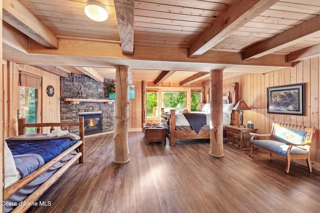 14318 N Waters Edge Ct, Hayden, ID 83835 - bedroom featuring multiple windows, wood walls, wood finished floors, wooden ceiling with exposed beams, and a stone fireplace