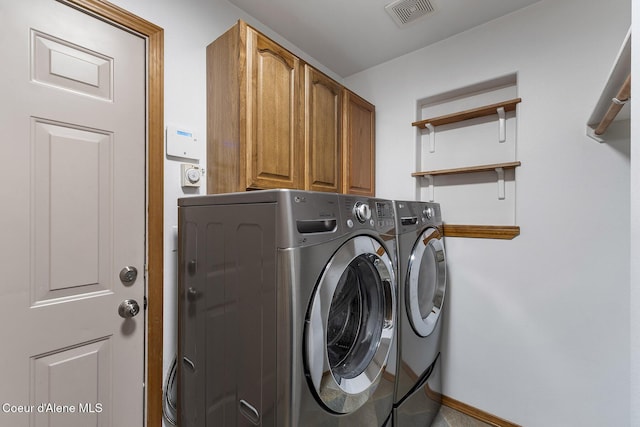 3025 N Sand Trap Way, Post Falls, ID 83854 - laundry room featuring washing machine and dryer, cabinet space, and baseboards