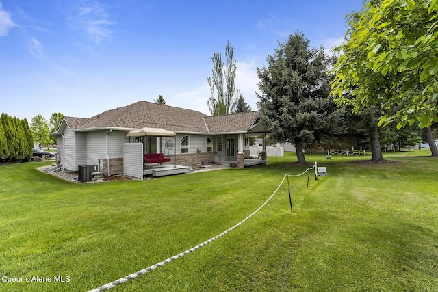 3025 N Sand Trap Way, Post Falls, ID 83854 - rear view of property with a lawn, central air condition unit, a patio area, and a shingled roof